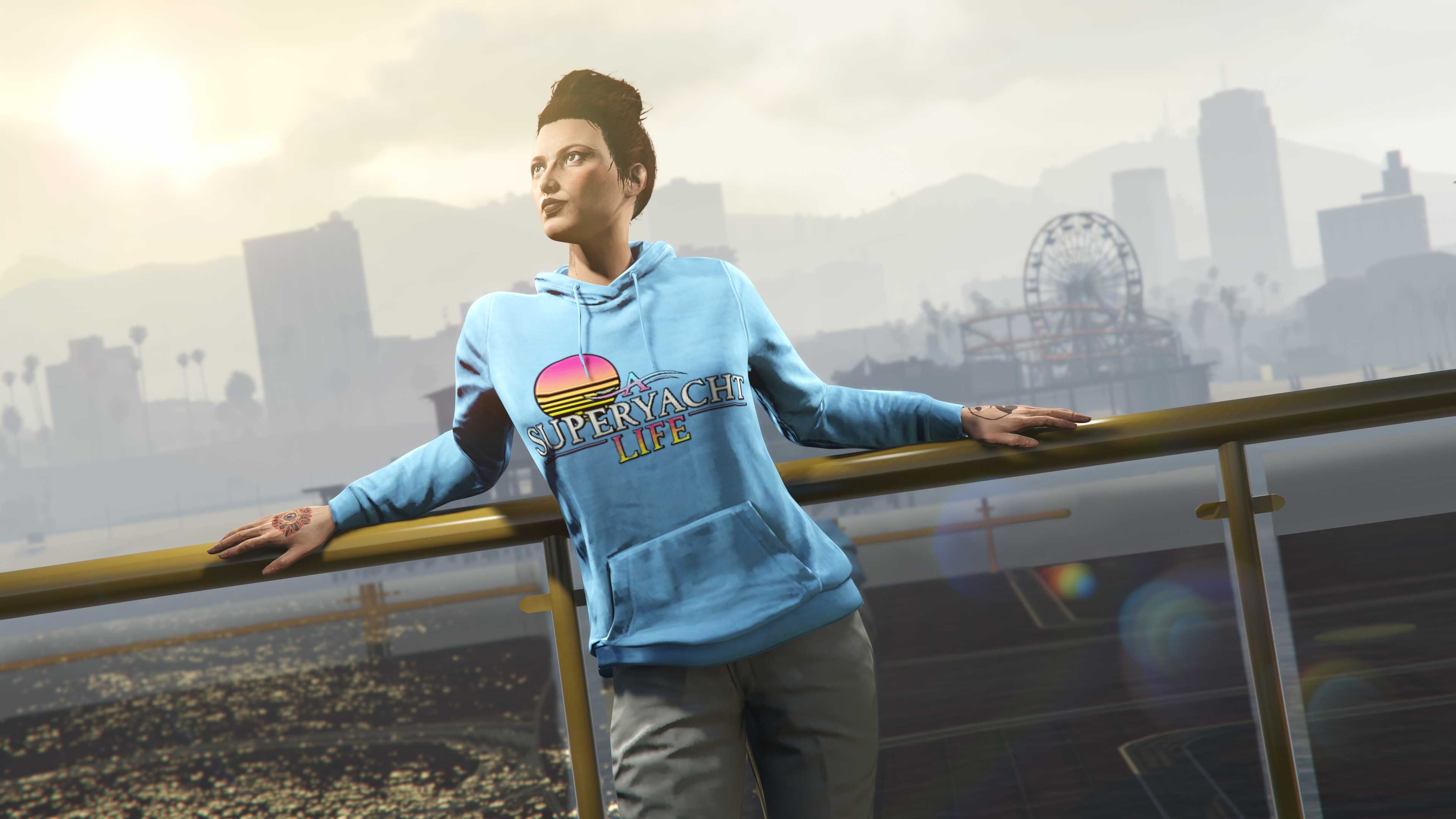 A character poses against a railing wearing their blue A Superyacht Life Hoodie with the logo and a retro '80s-themed sun graphic.