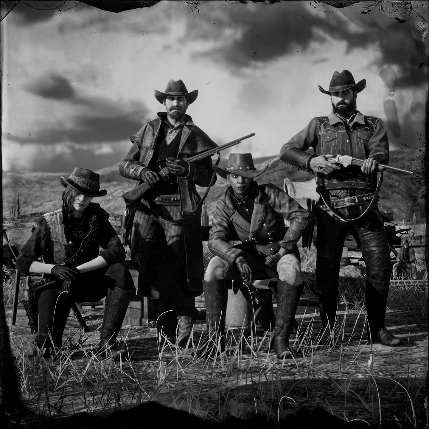 A posse of four pose together nearby rocky mountains.