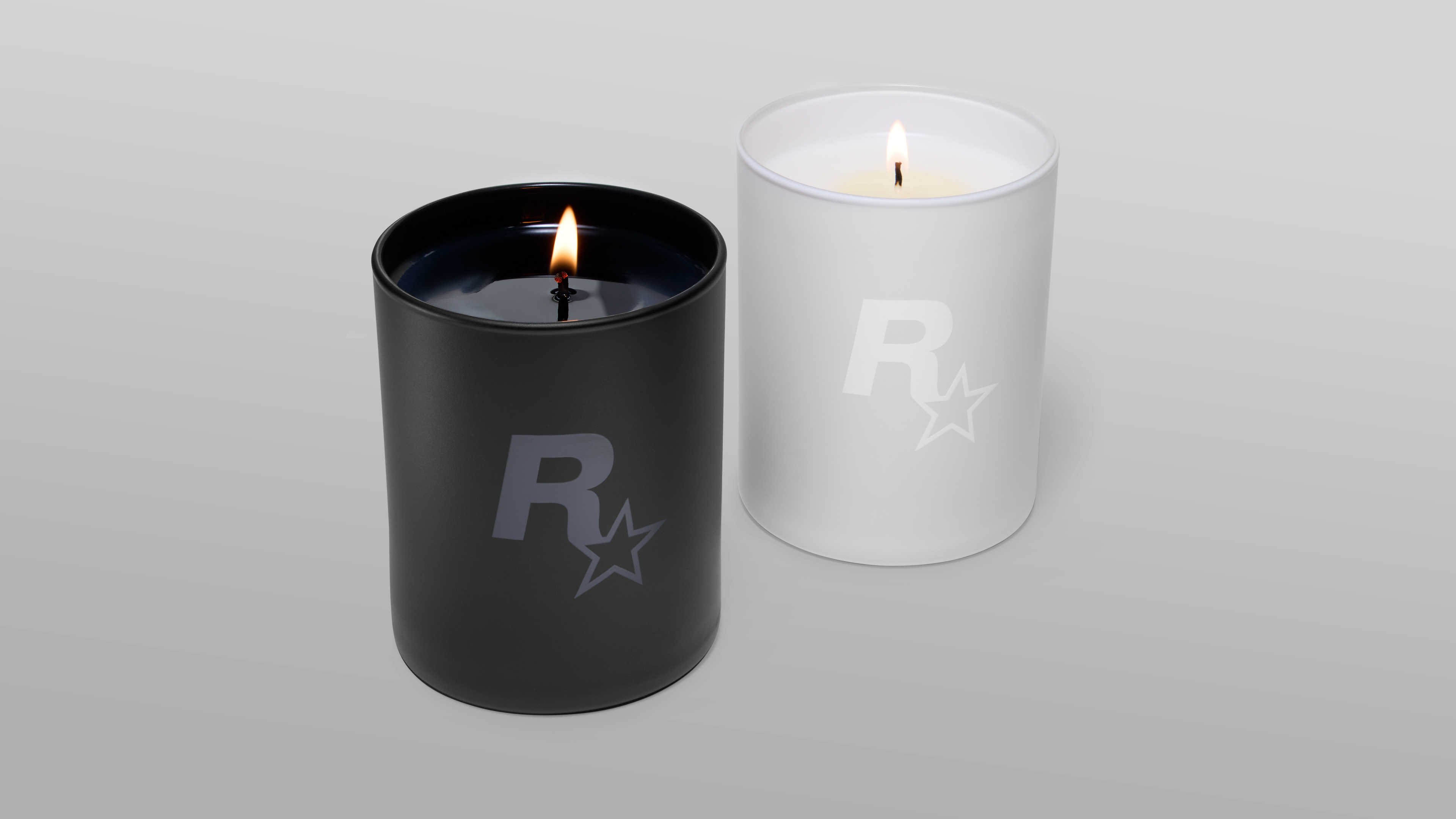 一黑一白两支蜡烛，侧面各有Rockstar Games标志。