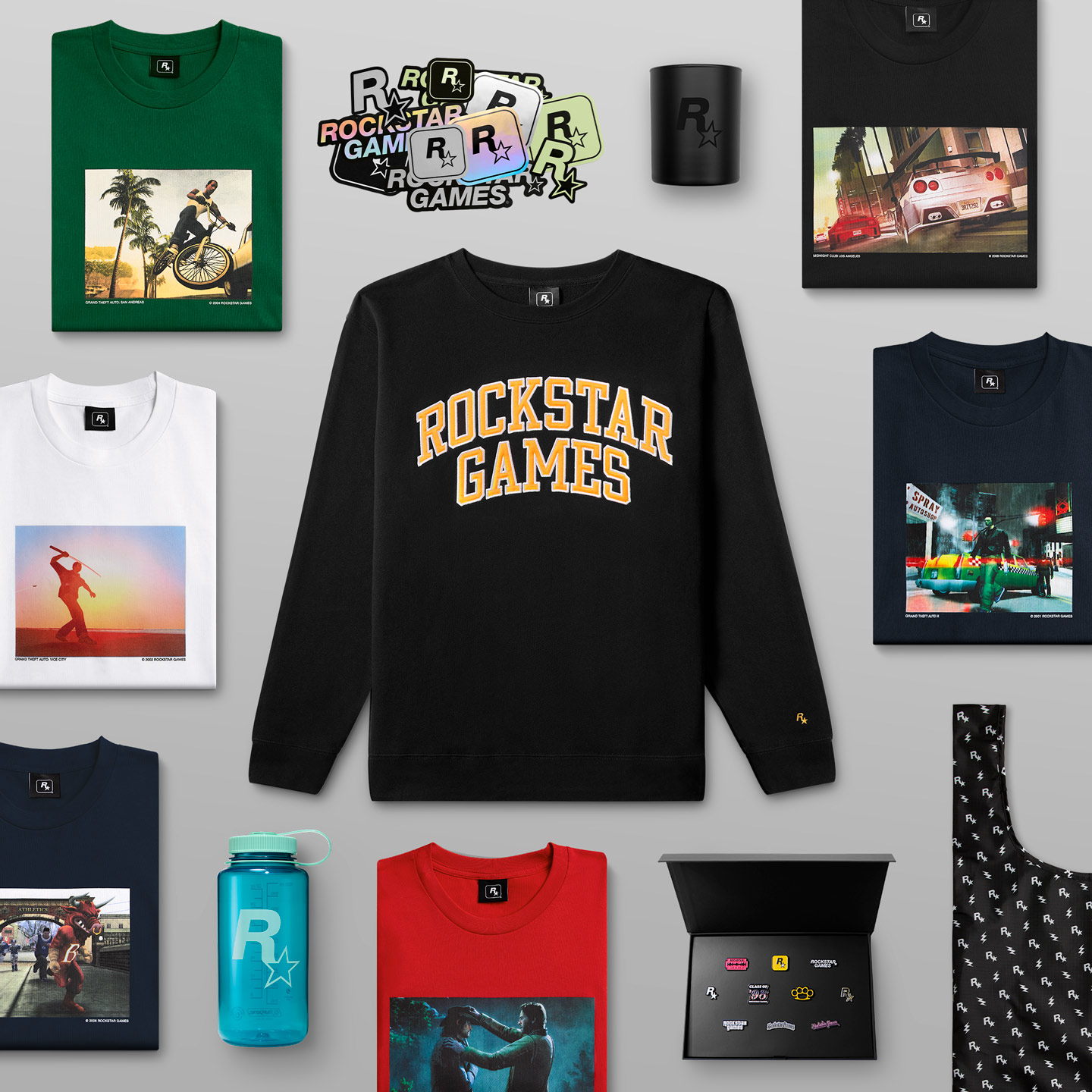 各种Rockstar Games收藏品和服饰，图片中央是有着橙色Rockstar Games字样的黑色圆领运动衫。